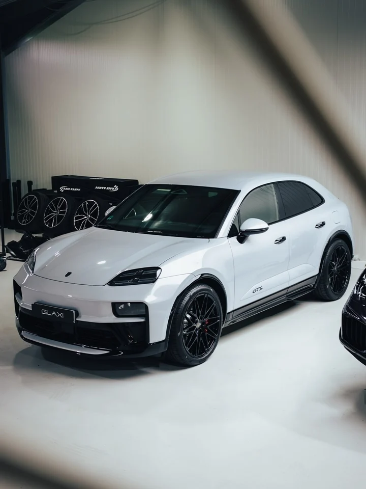 Perlmuttweißer elektrischer Porsche Macan GTS in der GLAXI-Halle