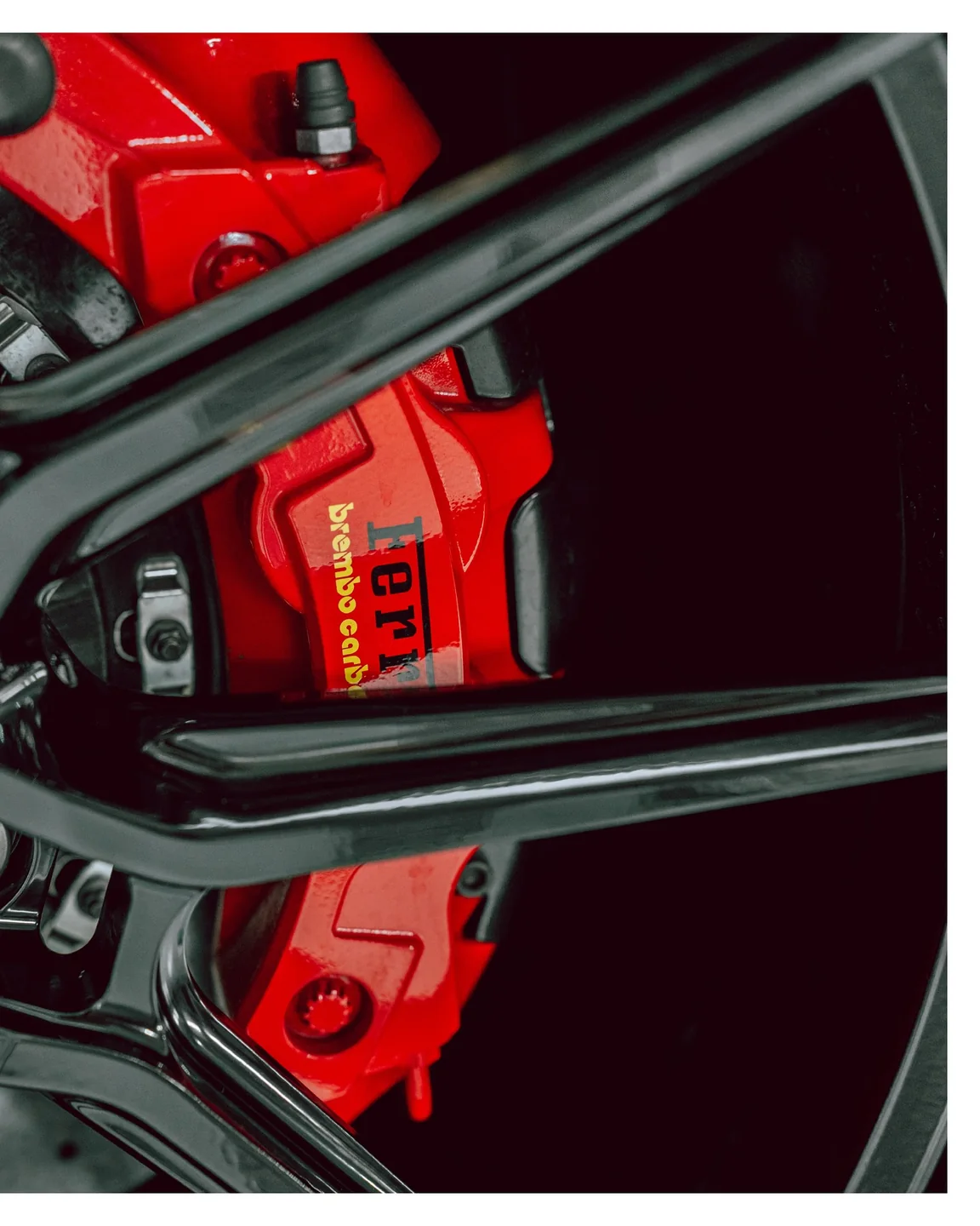 Roter Bremssattel hinter den schwarzen Radspeichen des Ferrari F8 Spider