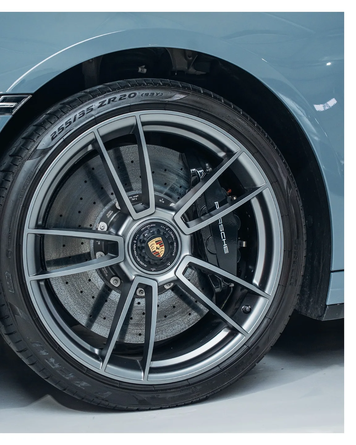 Porsche-Rad mit Zentralverschluss und sichtbarer Bremsscheibe am hellblauen Turbo S